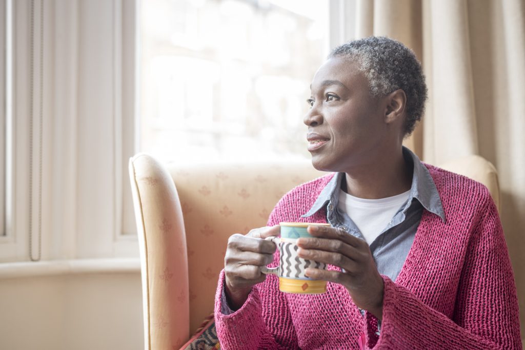 Neutral-mature-woman-with-drink_iStock_907956158_sm